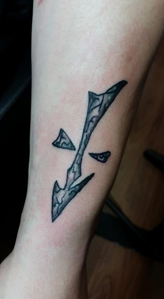 Stone cracked lightning bolt forearm tattoo