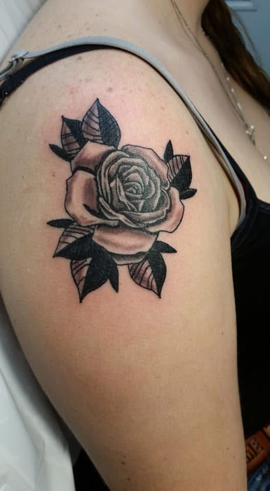 Black and grey rose with dark leaves shoulder tattoo