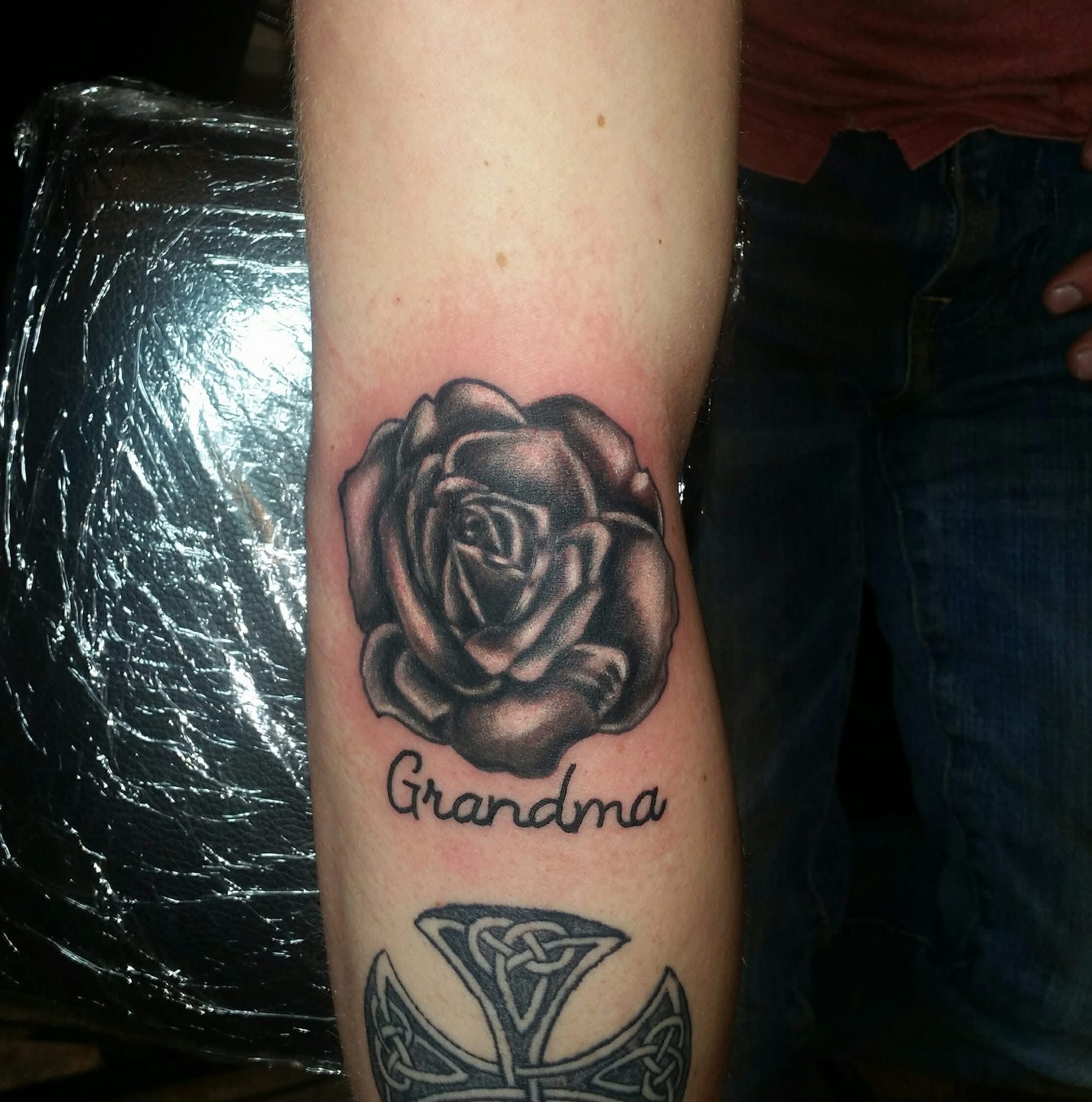 Black and grey rose with Grandma script and Celtic knotwork forearm tattoo