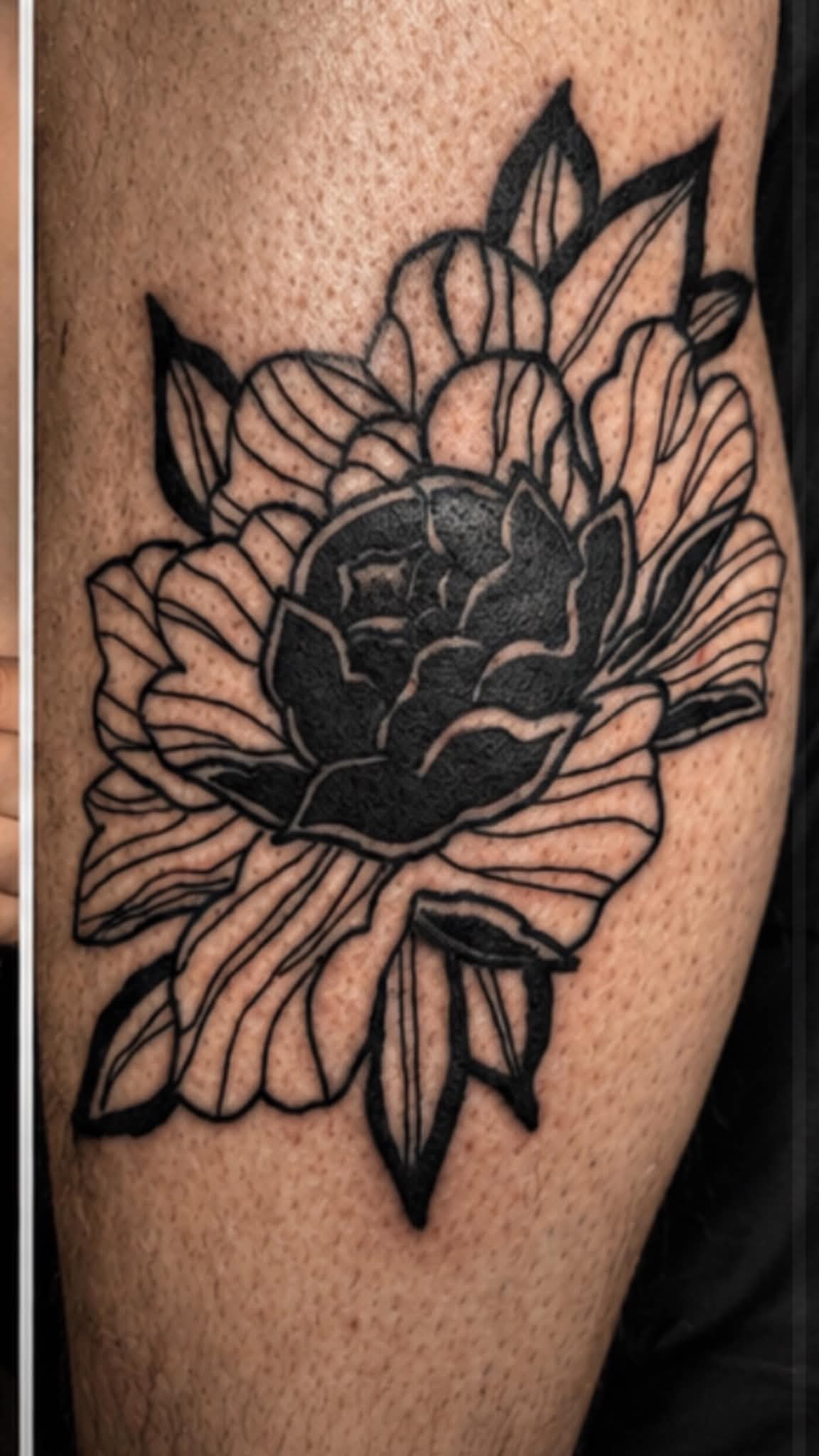 Bold blackwork peony flower arm tattoo