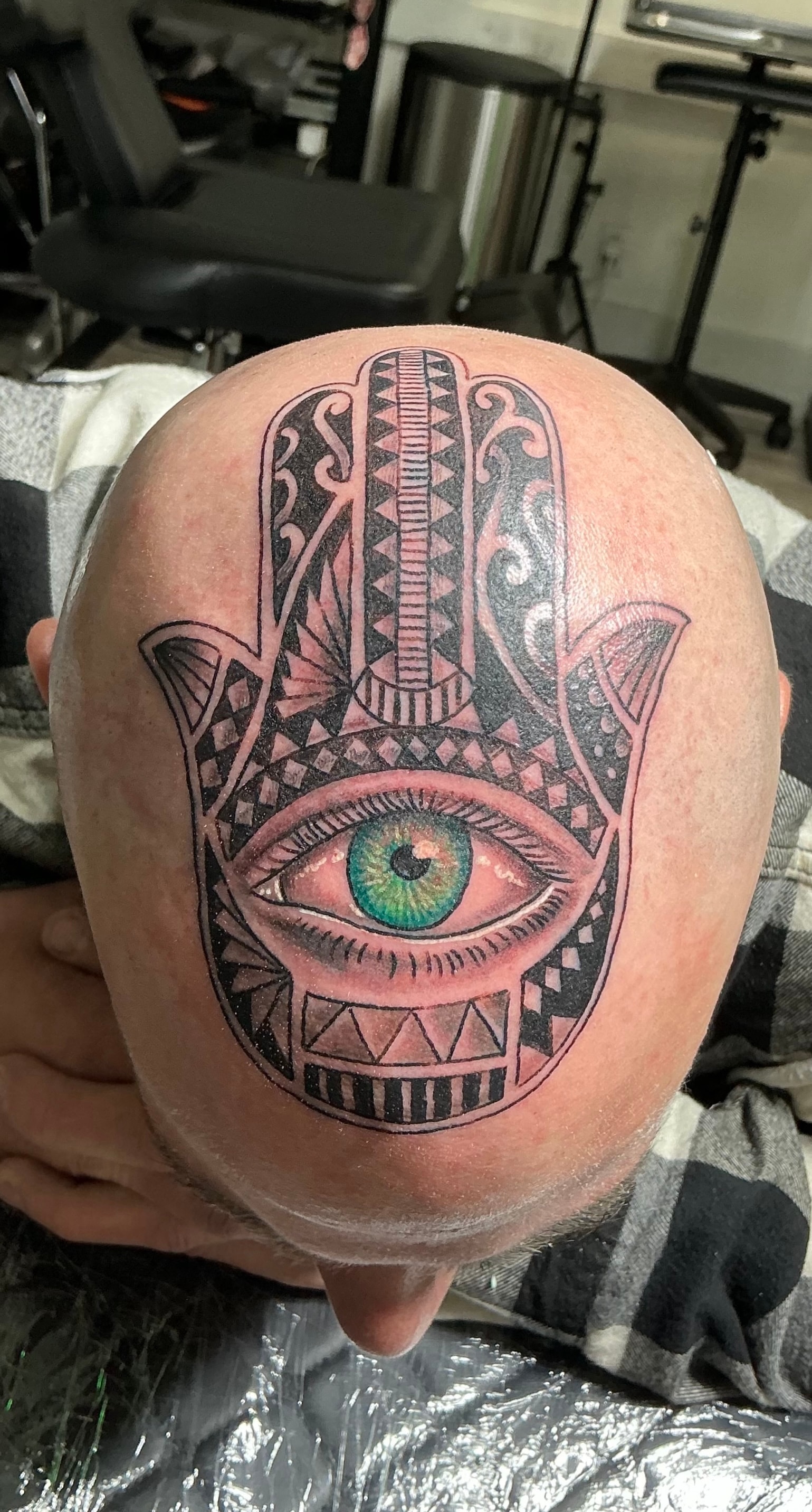 Randy DeShong hamsa hand with eye head tattoo