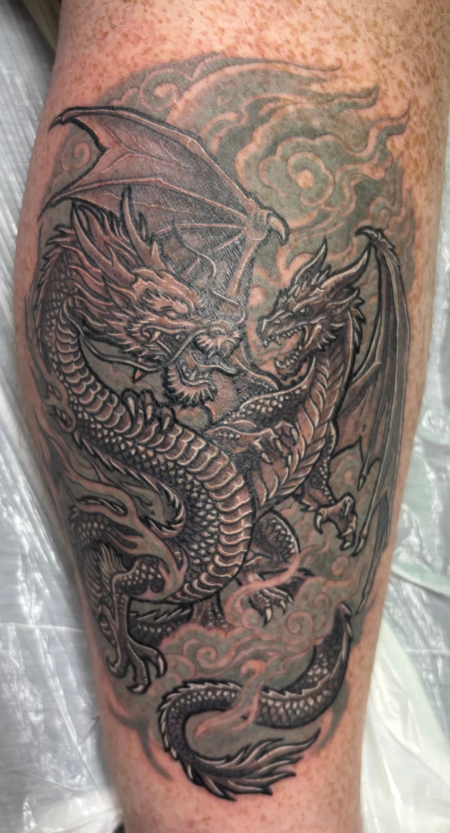 Randy DeShong black and grey dragon leg tattoo