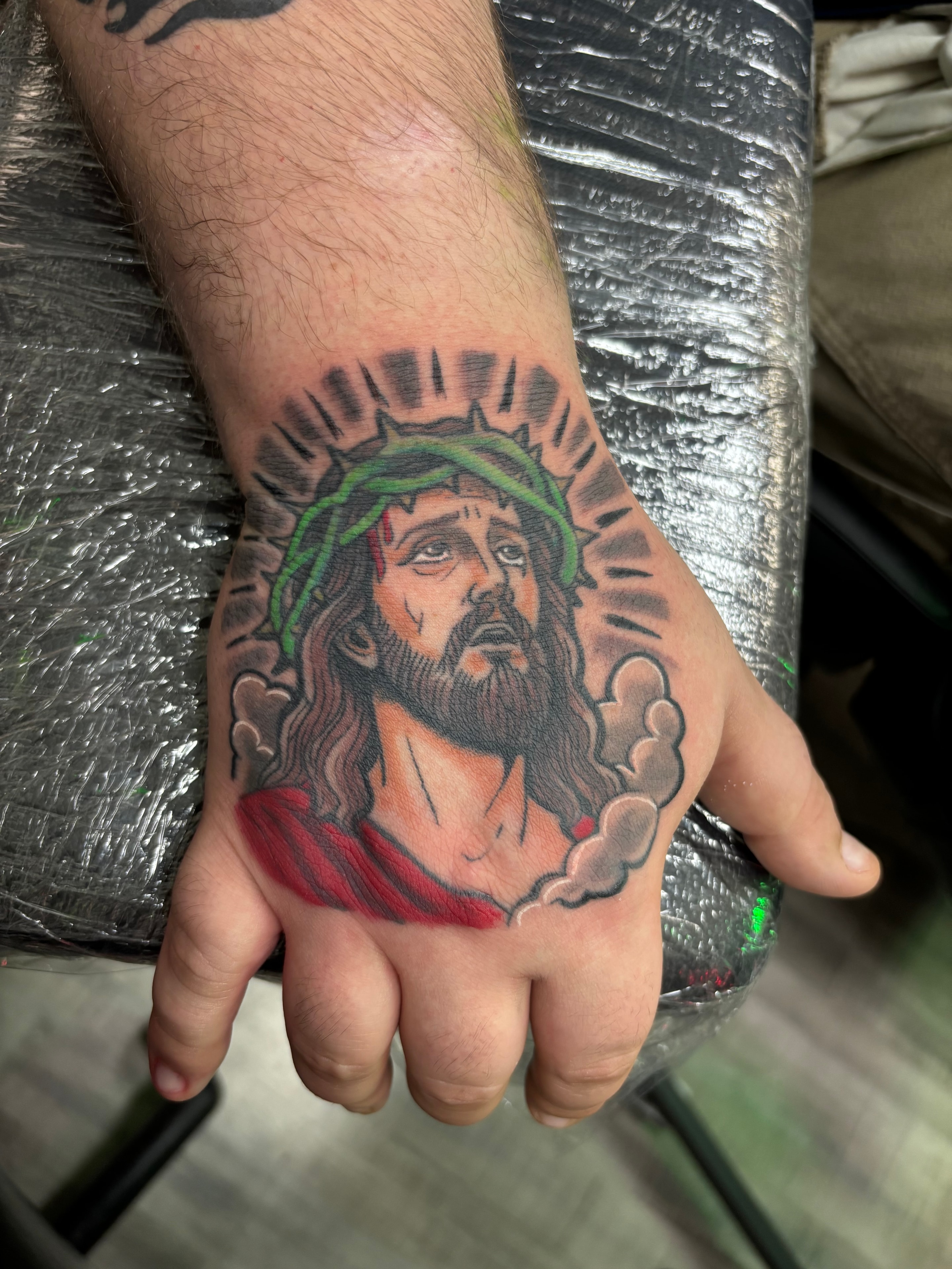 Randy DeShong Jesus crown of thorns hand tattoo